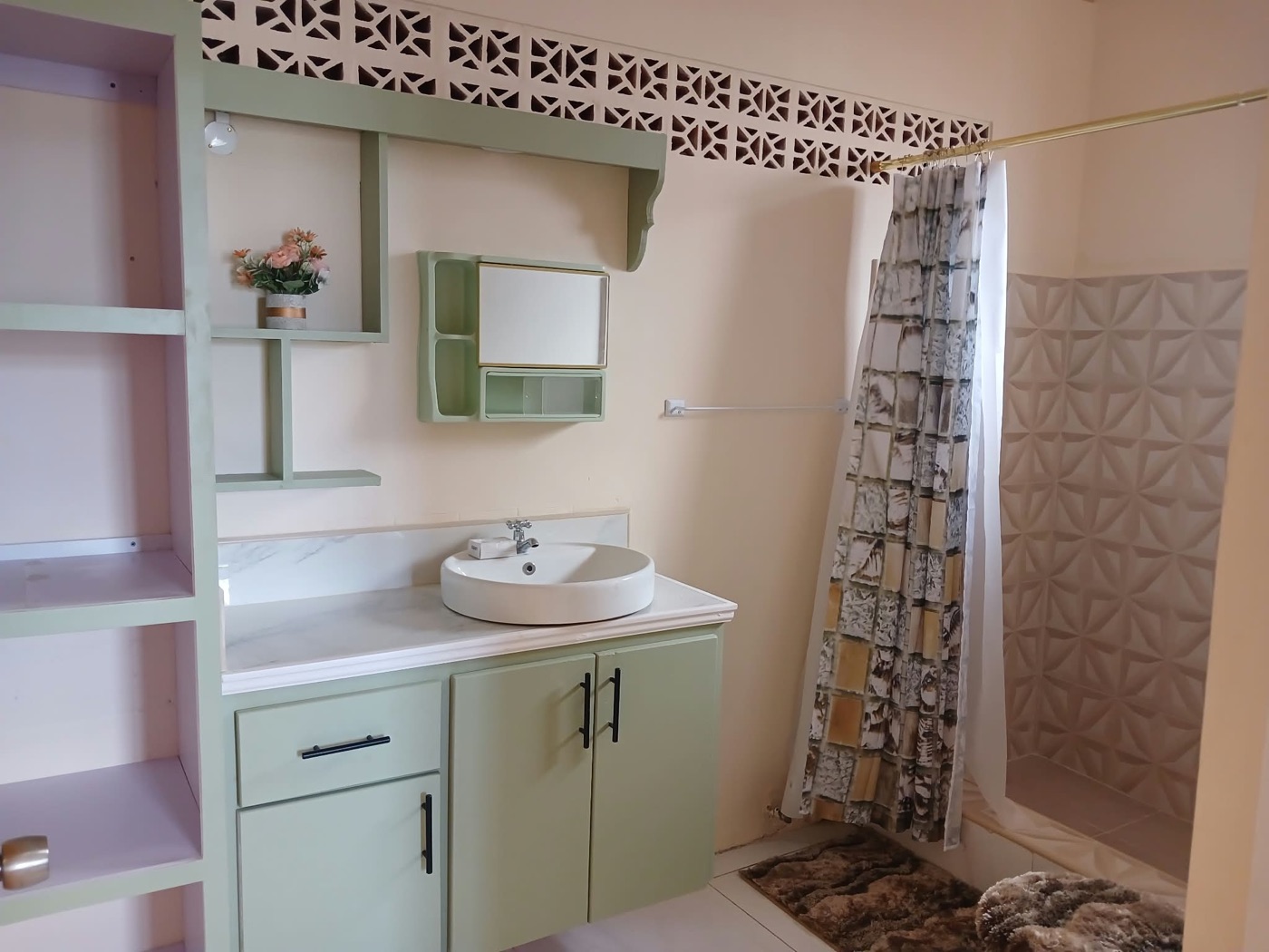 En-suite bathroom with sage vanity, round basin and walk-in shower