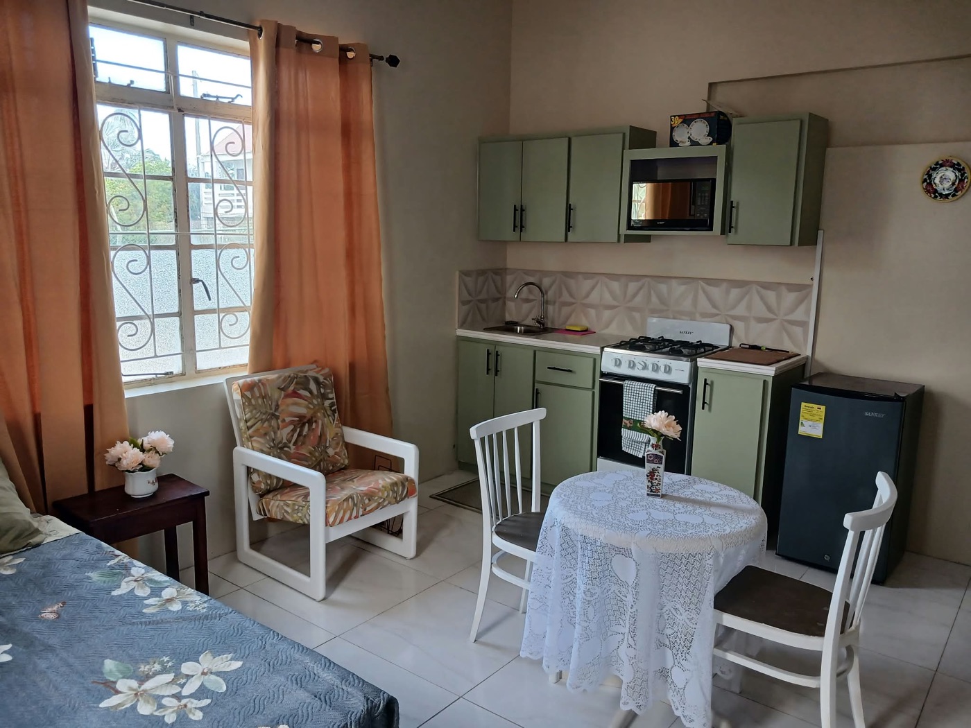 Apartment 1 sage-green kitchenette and dining table