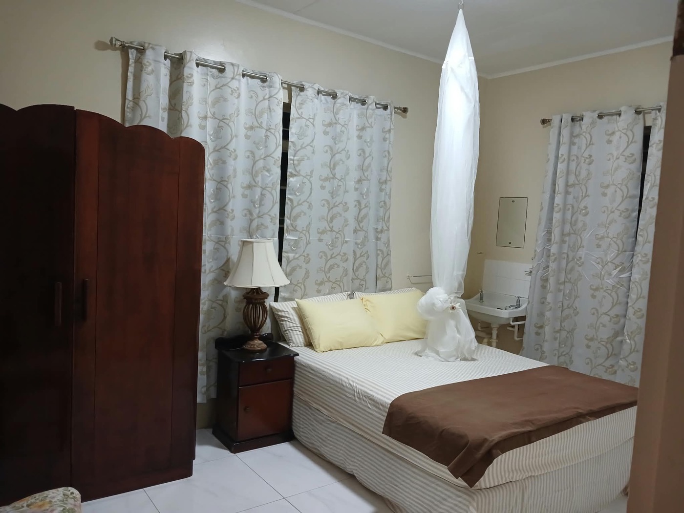 Bedroom one's mahogany wardrobe and bedside lamp