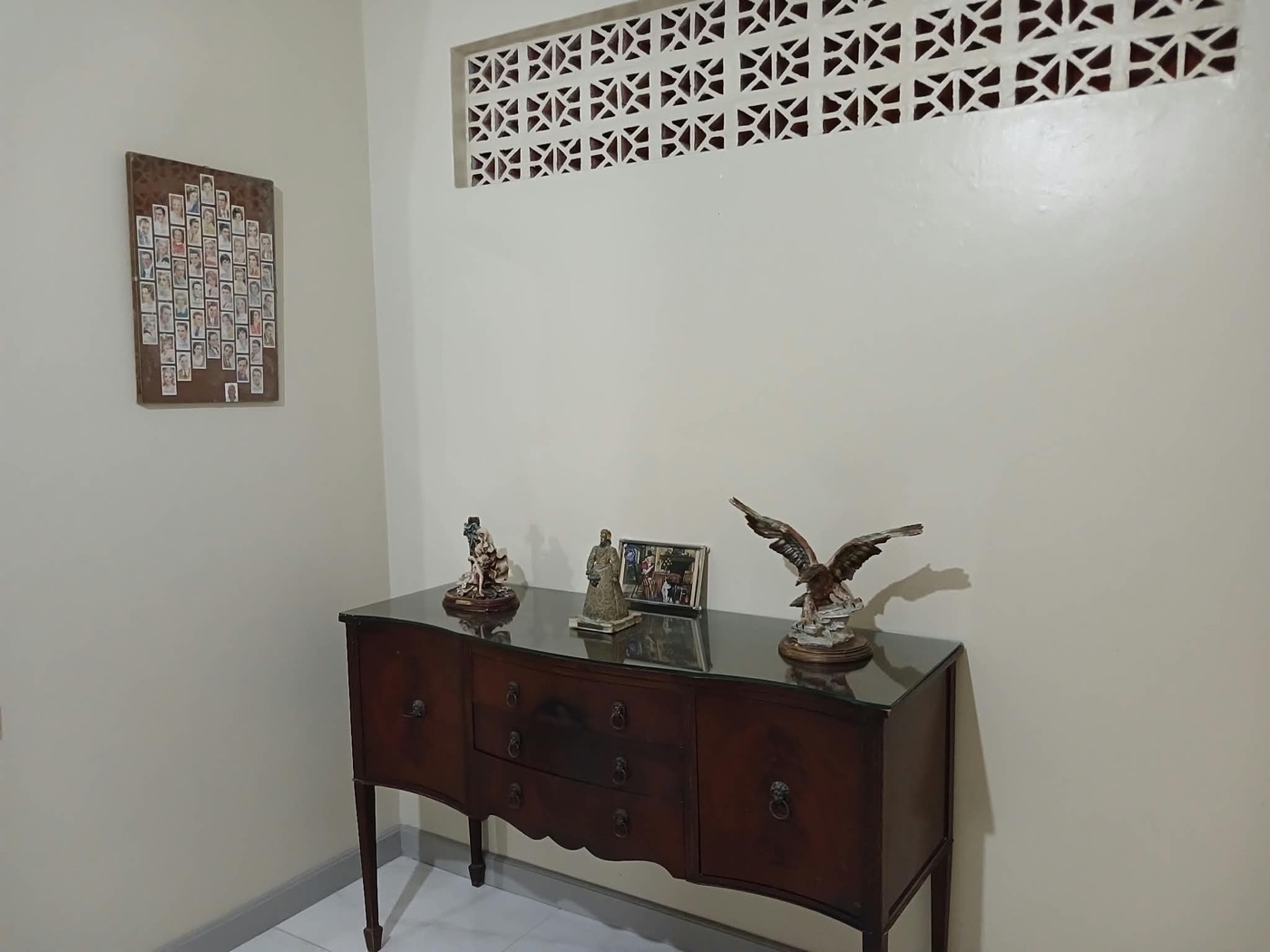 Entry with antique mahogany sideboard and eagle figurine
