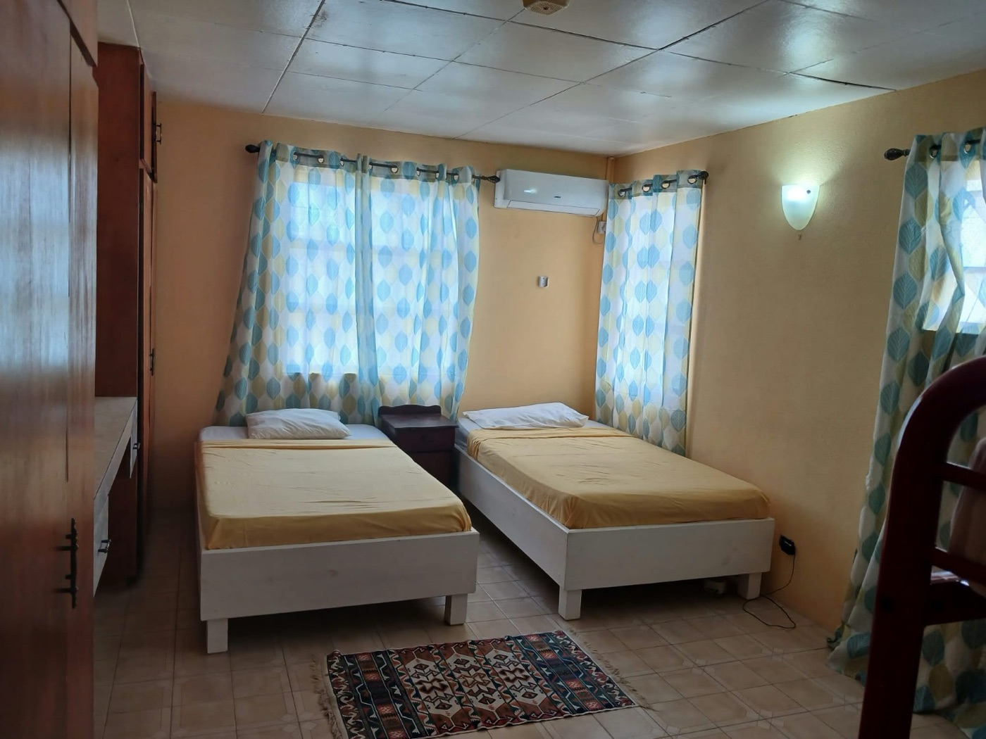 Apartment 3's twin bedroom in yellow linens